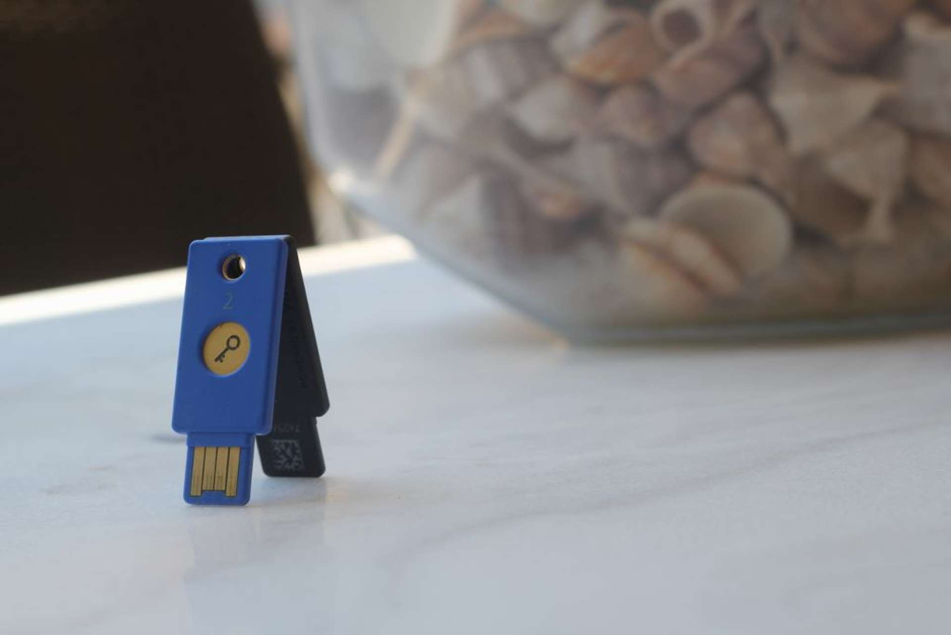 Two yubikeys balancing against each other on a table
